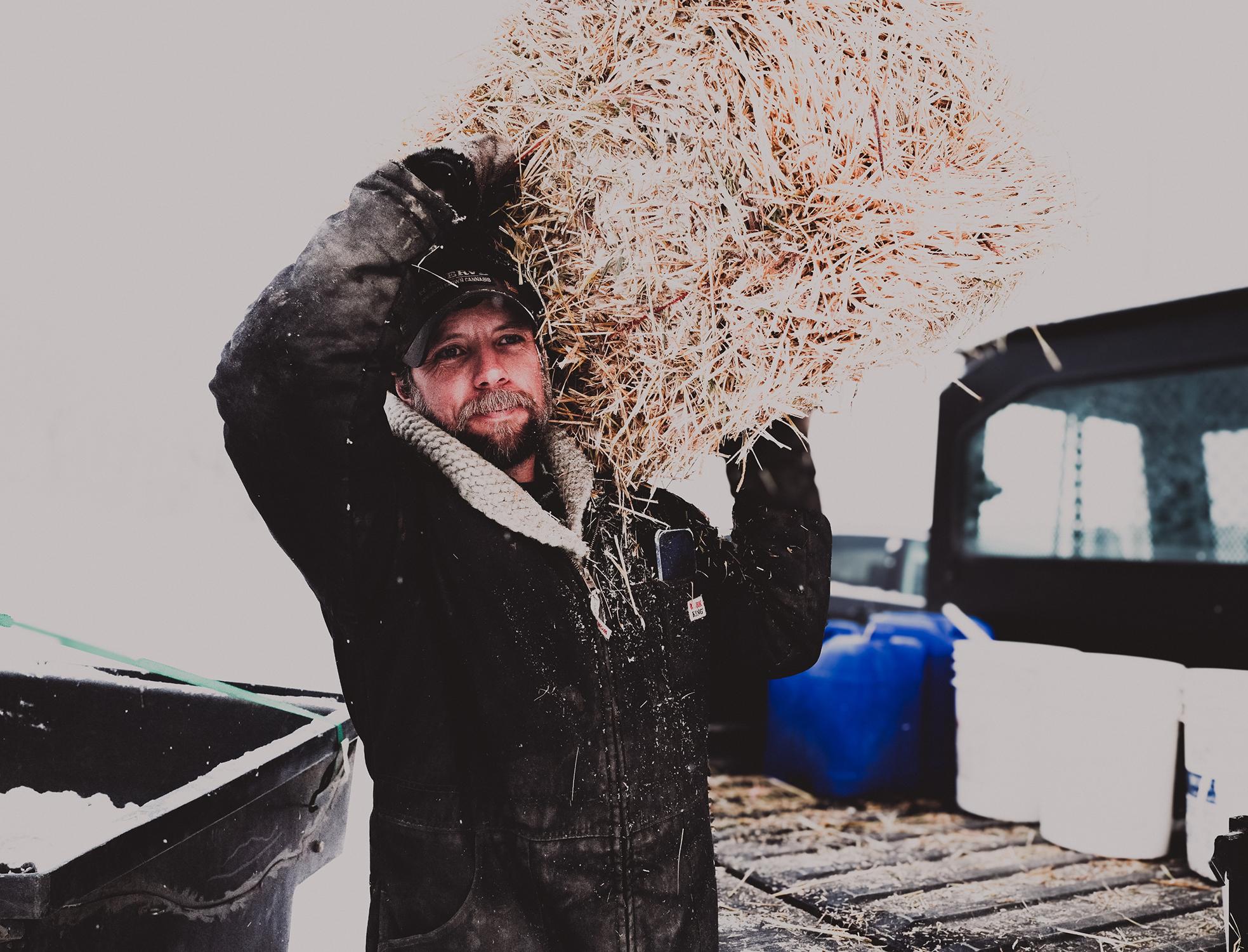 Across Canada Voices are Rising - Farmer lifting hay Across Canada Voices are Rising - Farmer lifting hay